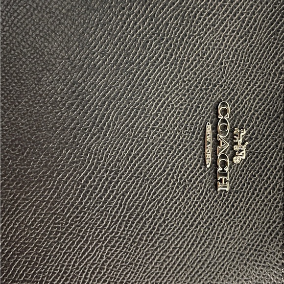 Stylish Coach wristlet in a deep dark blue color with a sleek design. - Picture 2 of 7